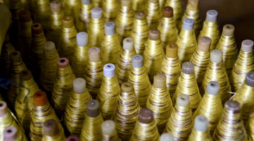 Yellow silk bobbins with Ikat tie dye ready for handloom weaving