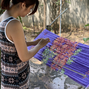 A member of Maithong Suranaree Co-operative creating the tie-dye pattern for Rare & Fair's Ikat Silk